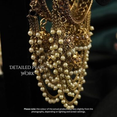 Kundan-style bridal bangle set with hanging jhumka details